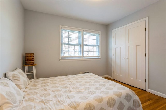 bedroom with a closet and hardwood / wood-style flooring