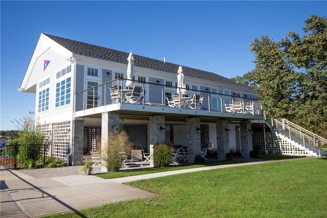 back of house with a balcony, a yard, and a patio