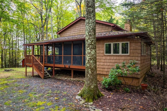 rear view of property with a sunroom