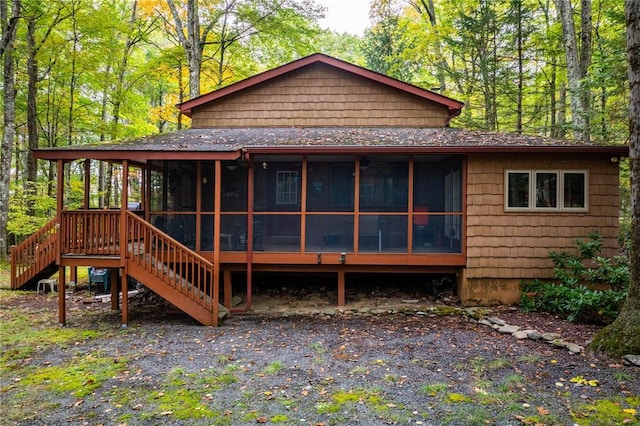 rear view of property featuring a sunroom