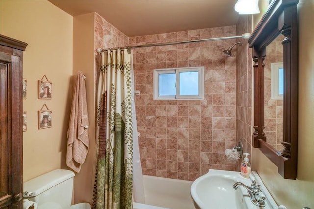 full bathroom featuring sink, shower / bath combo with shower curtain, and toilet