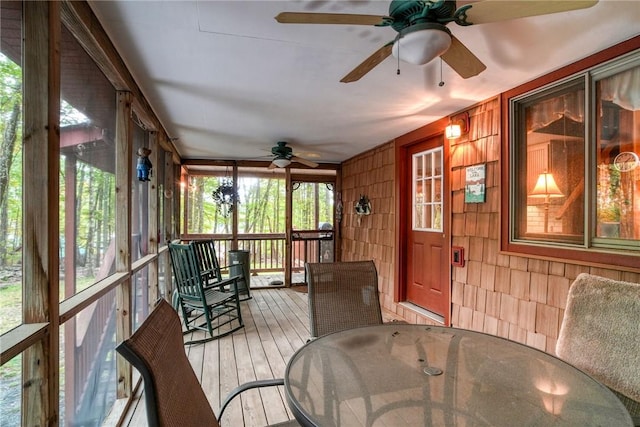 sunroom featuring ceiling fan