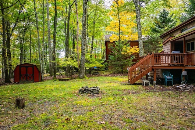 view of yard with a storage shed and a deck