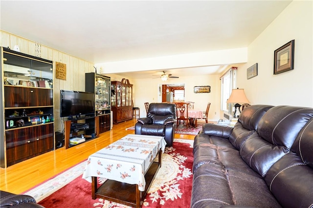 living room with hardwood / wood-style flooring and ceiling fan