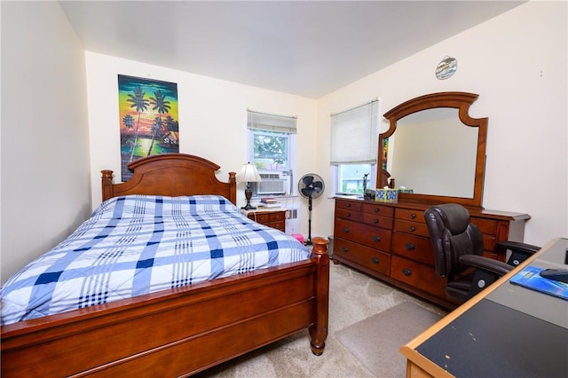 bedroom with cooling unit and light colored carpet