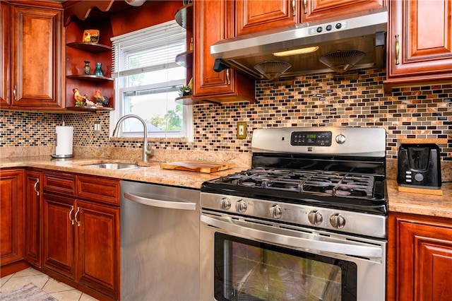 kitchen featuring backsplash, light stone counters, stainless steel appliances, extractor fan, and sink