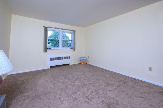 carpeted empty room with radiator