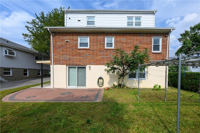 rear view of house with a yard and a patio area