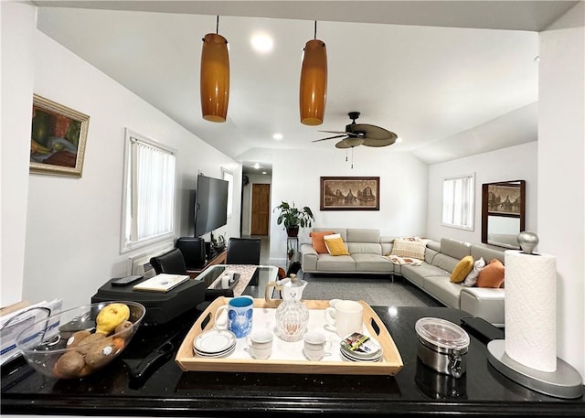 living room featuring ceiling fan and lofted ceiling