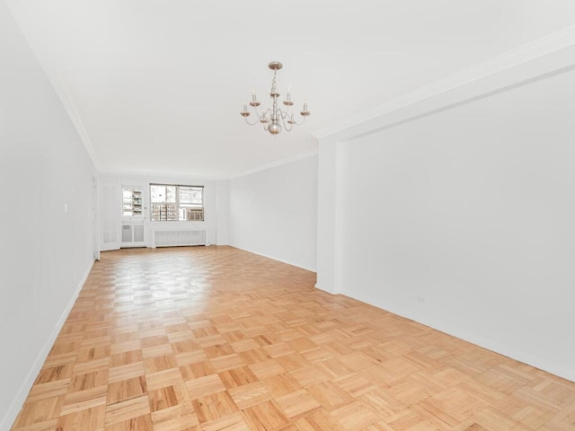 unfurnished living room with radiator heating unit, an inviting chandelier, light parquet floors, and crown molding