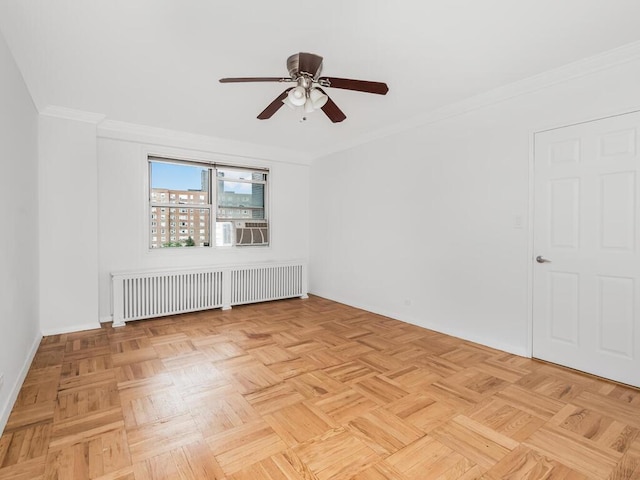 spare room with ceiling fan, ornamental molding, radiator, and light parquet floors