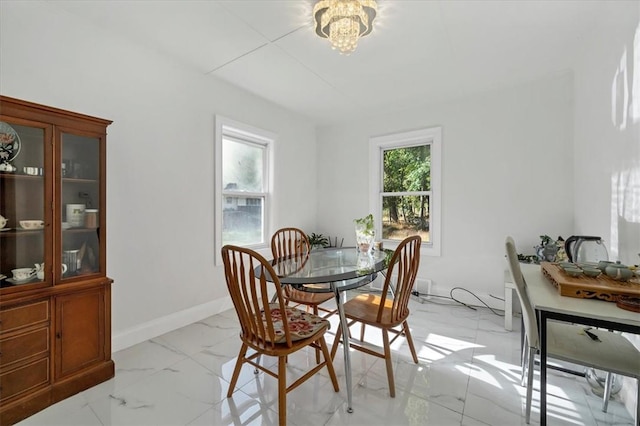 dining room featuring plenty of natural light and a notable chandelier