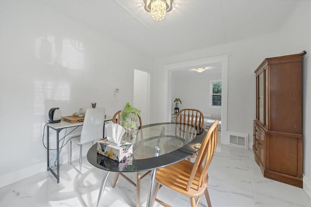 dining space featuring an inviting chandelier