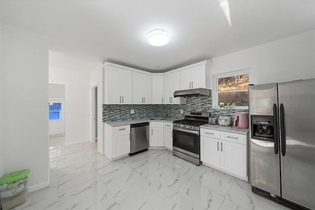 kitchen with backsplash, stainless steel appliances, and white cabinetry