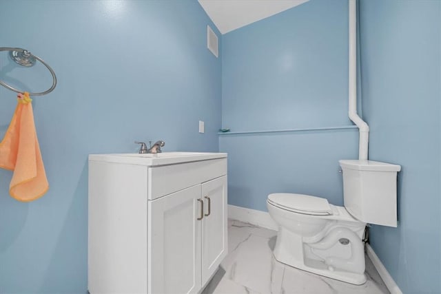 bathroom with vanity, toilet, and lofted ceiling