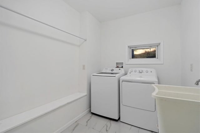 clothes washing area featuring separate washer and dryer and sink