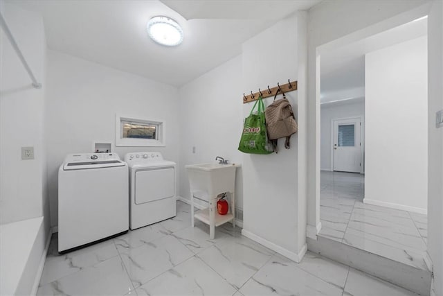 clothes washing area with sink and washing machine and clothes dryer