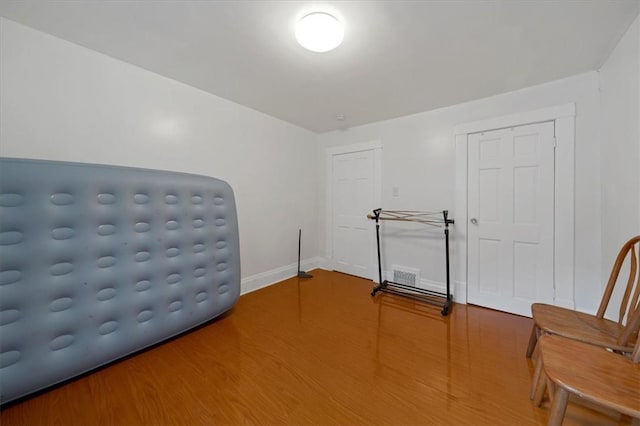 sitting room with wood-type flooring