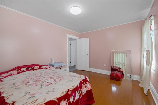 bedroom featuring hardwood / wood-style flooring and crown molding