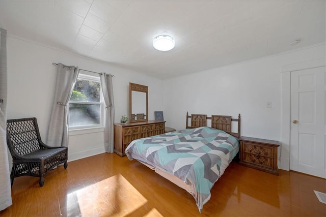 bedroom with hardwood / wood-style flooring