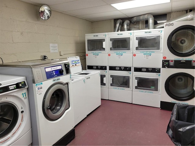 washroom with stacked washer and dryer, light tile patterned flooring, and washer and dryer