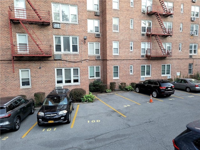 view of building exterior featuring an AC wall unit and cooling unit