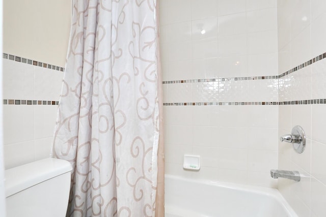 bathroom featuring toilet, tile walls, and shower / bath combo with shower curtain