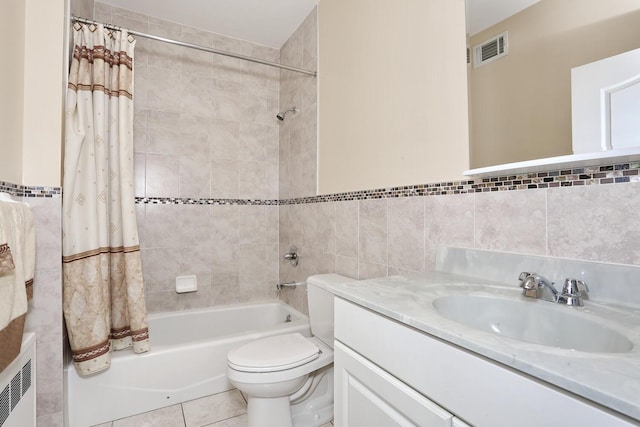 full bathroom featuring vanity, shower / tub combo with curtain, tile walls, tile patterned flooring, and toilet