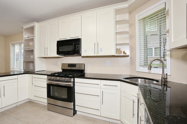 kitchen featuring white cabinets, stainless steel range with gas cooktop, and a wealth of natural light