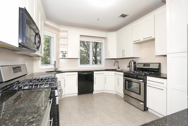 kitchen with black appliances, dark stone countertops, and white cabinetry