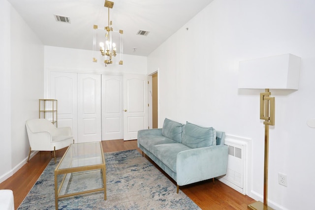 living area featuring dark wood-type flooring and a notable chandelier