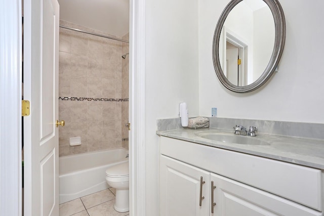 full bathroom featuring tile patterned floors, vanity, tiled shower / bath, and toilet