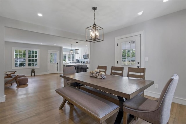 dining area with a chandelier and light hardwood / wood-style floors