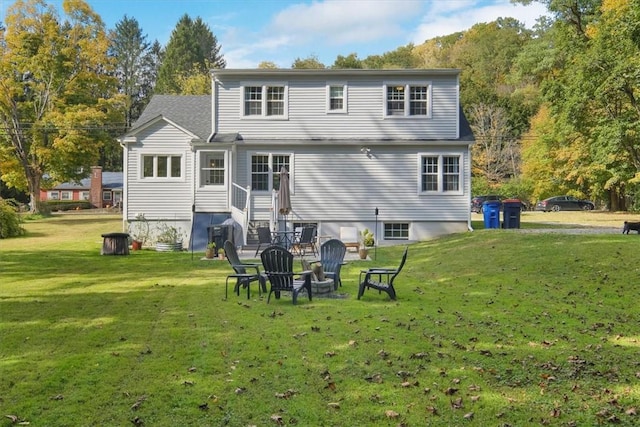 rear view of house featuring a yard