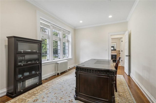 office featuring radiator heating unit, hardwood / wood-style flooring, and ornamental molding