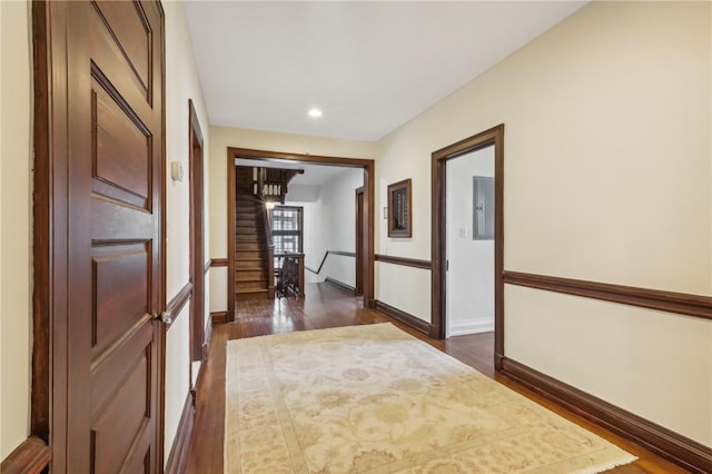 hall with electric panel and dark wood-type flooring