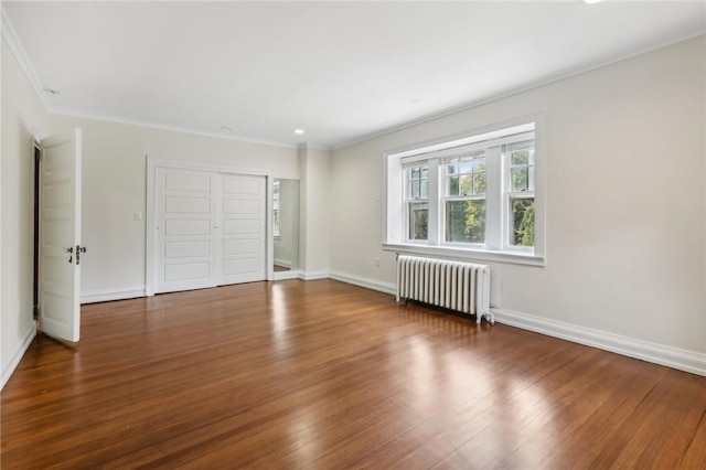 interior space with crown molding, radiator heating unit, and dark hardwood / wood-style floors