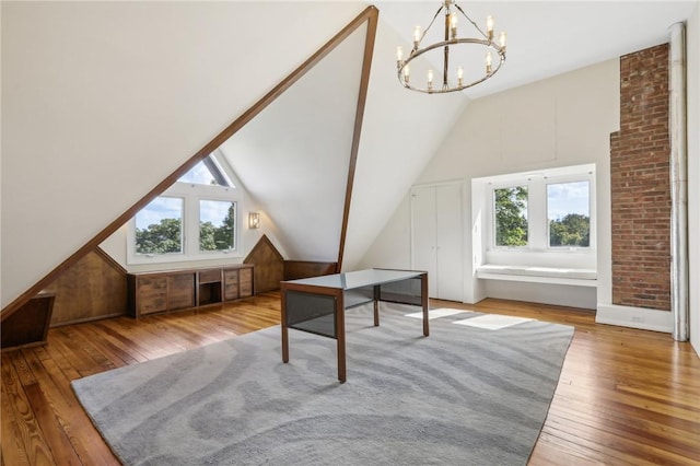 bonus room with a chandelier, hardwood / wood-style floors, and vaulted ceiling with beams