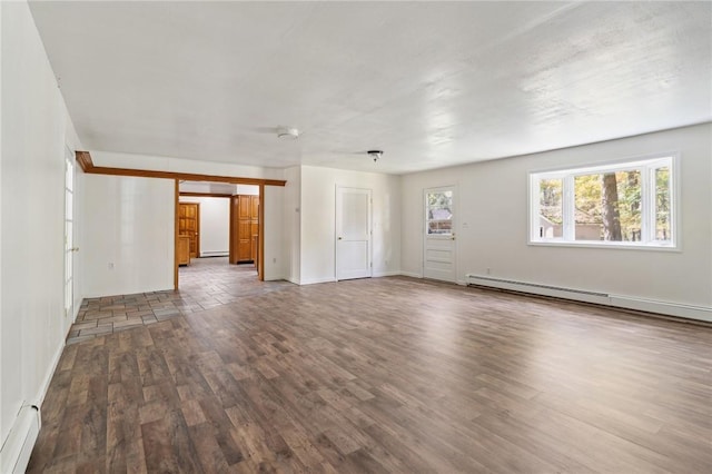 unfurnished living room with baseboards, wood finished floors, a baseboard heating unit, and a baseboard radiator