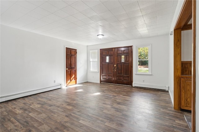 foyer entrance with a baseboard radiator, baseboard heating, wood finished floors, and baseboards