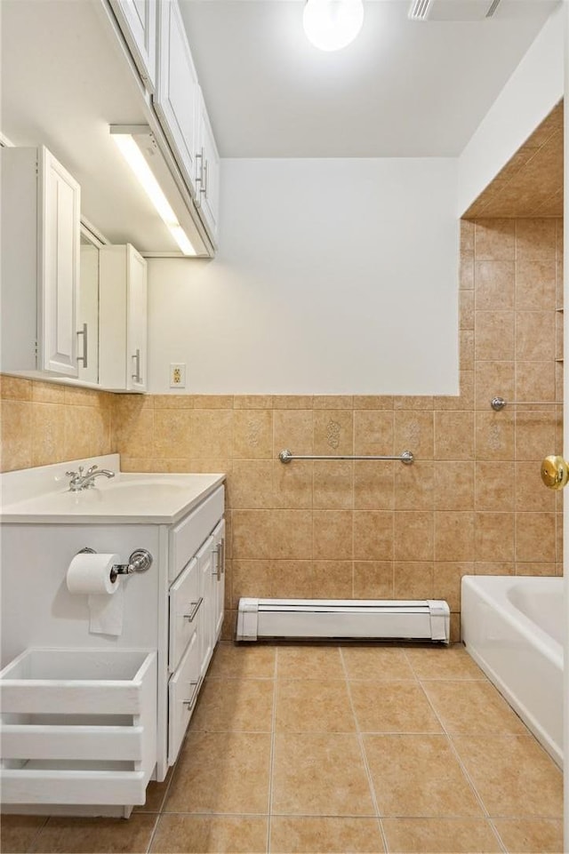 full bathroom featuring vanity, a baseboard radiator, tile patterned flooring, and tile walls