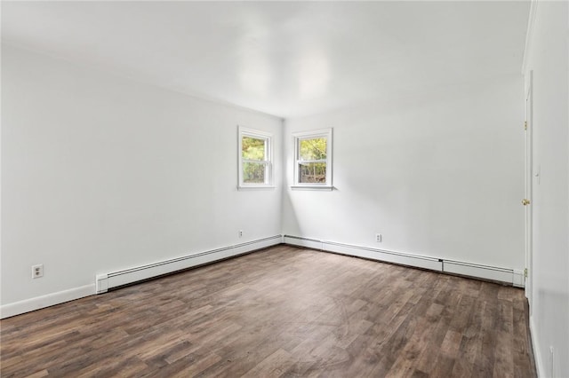 empty room with a baseboard radiator, wood finished floors, and a baseboard heating unit