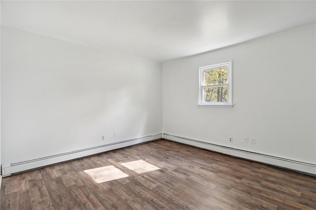 spare room featuring wood finished floors and a baseboard radiator