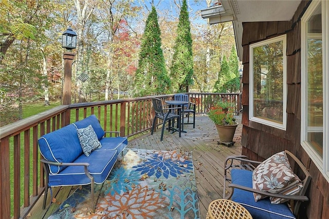 wooden deck with an outdoor living space