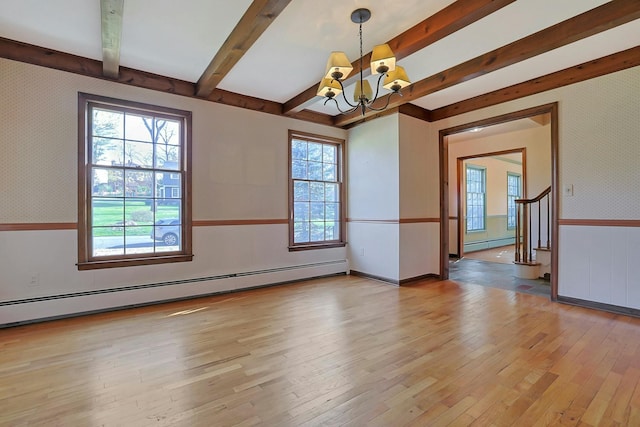 unfurnished room featuring beamed ceiling, a notable chandelier, baseboard heating, and light hardwood / wood-style flooring