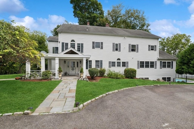 view of front of home with covered porch and a front yard