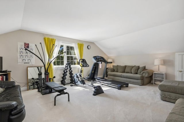 workout room featuring light carpet and vaulted ceiling