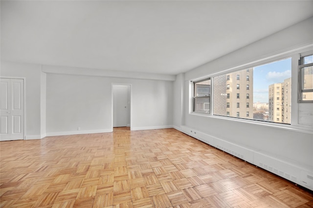 unfurnished room featuring light parquet flooring