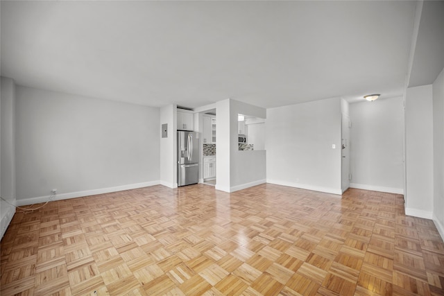 unfurnished living room with light parquet flooring