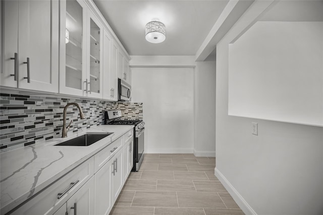 kitchen featuring sink, white cabinetry, and stainless steel appliances